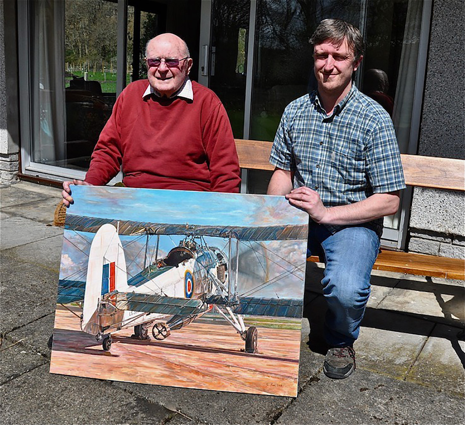 Lt Cdr John Moffat with Steven and his oil painting of the Fairey Swordfish Mk11 LS326 in 2013 