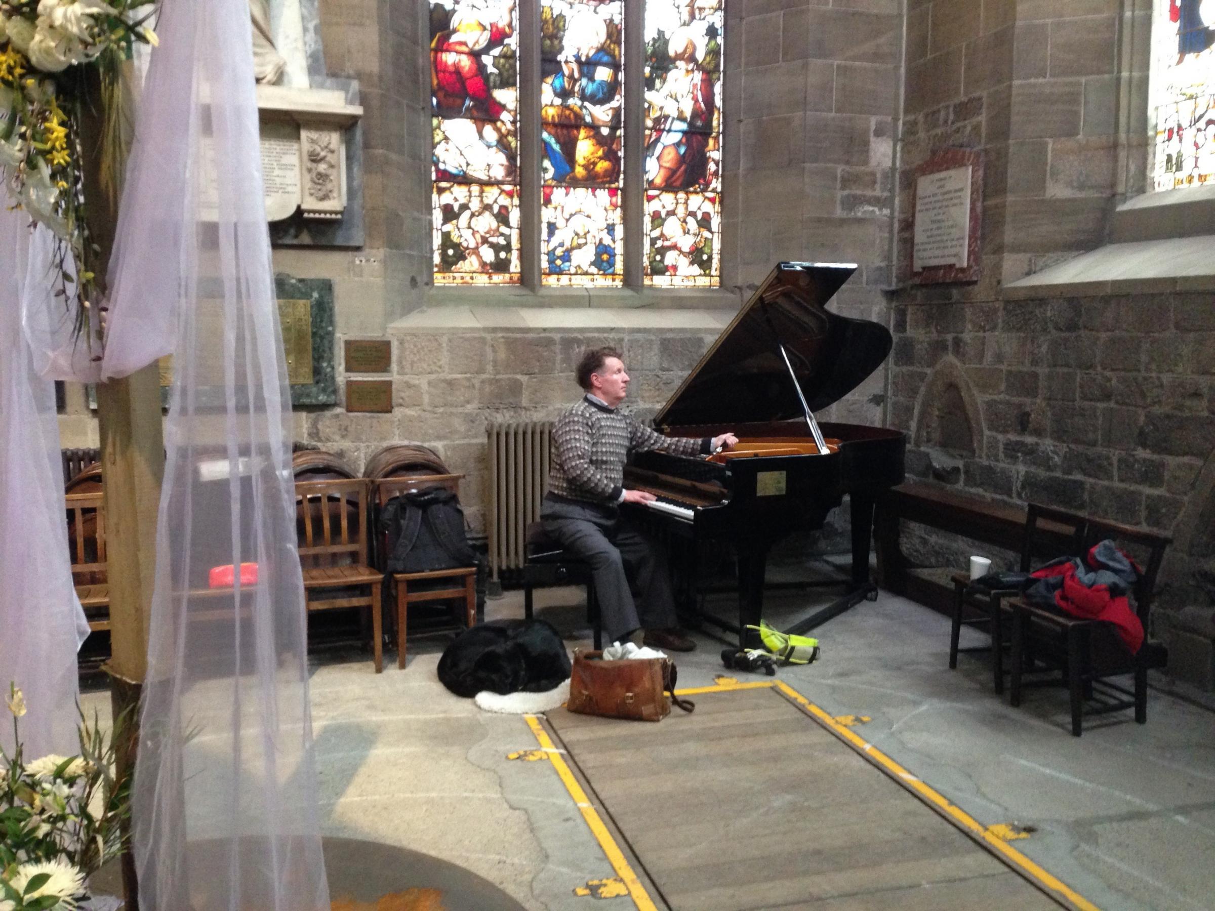 Gavin Atkinson and Winter tuning the piano at Newcastle Cathedral