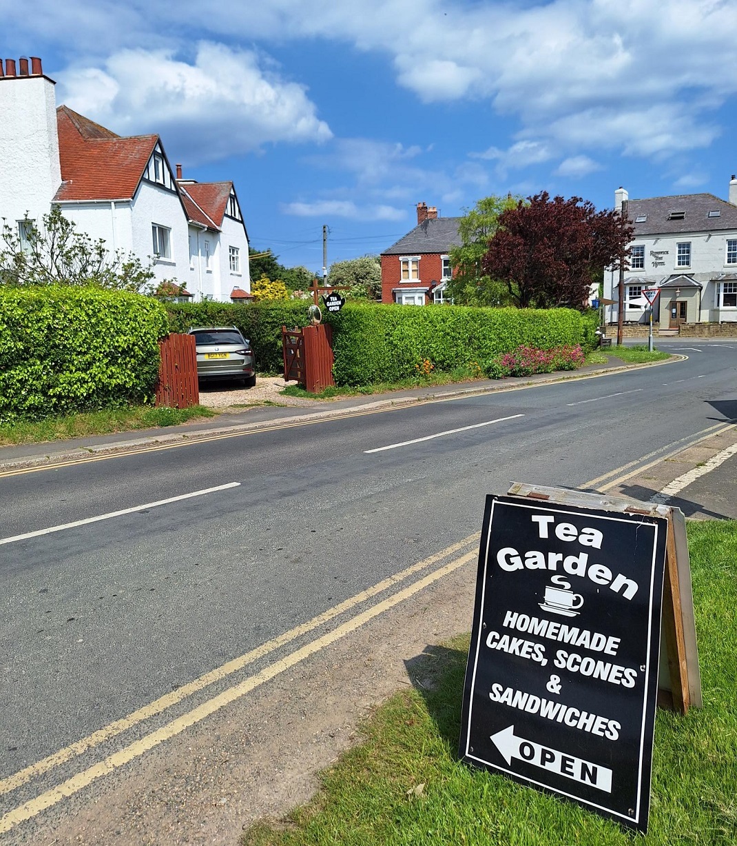 Pointing the way to the tea garden beside the bus stop at the top of the bank in Runswick Bay